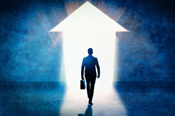 Business success concept. Businessman silhouette advancing in the direction of the bright arrow on the wall.