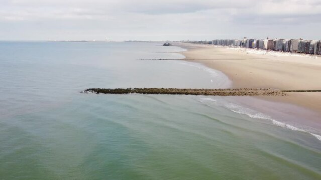 Aerial view of sunset, sandy beaches and endless ocean near Blankenberge, region of Flanders, Belgium. Evening light