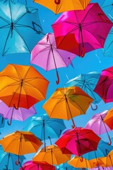 Fototapeta na wymiar Colorful umbrellas floating in the air, creating a vibrant and whimsical scene. Perfect for adding a touch of joy and creativity to any project