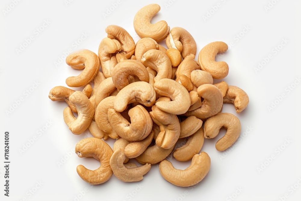 Poster a pile of cashews on a white surface. perfect for use in food and snack-related projects