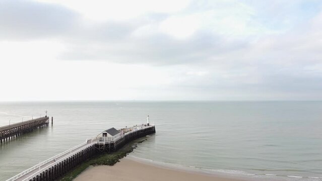 Aerial view of the white wooden pier in the town of Blankenberge on the Atlantic coast of Belgium during the morning sun