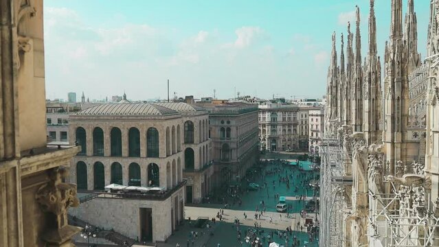 Aerial roof view of famous statue on cathedral Duomo di Milano Cathedral in front of the Victor Emmanuel II Gallery in Piazza. View of krishy houses. Architetture Statues on the spiers of the building