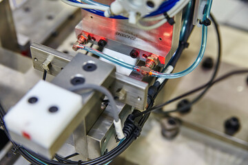 Industrial Automation Close-Up: Mechanical Clamp and Sensor Detail - obrazy, fototapety, plakaty