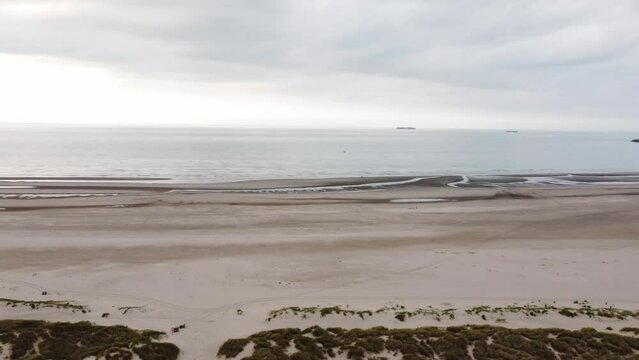 Aerial view of sunset, sandy beaches and endless ocean near Blankenberge, region of Flanders, Belgium. Evening light