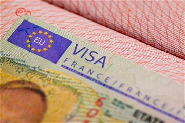 Schengen visa of France in the passport, closed border of EC. Close-up