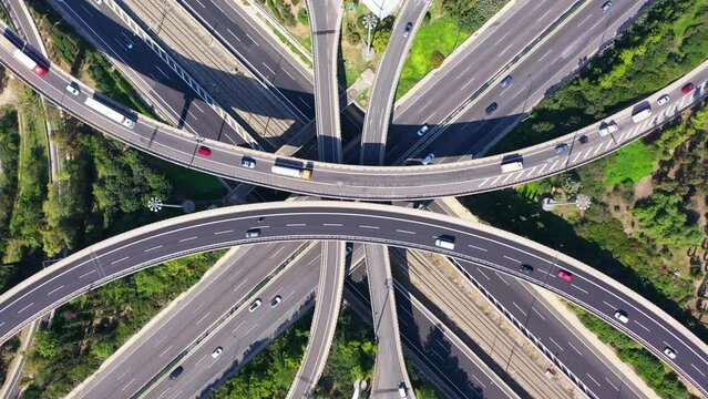 Aerial drone top down time lapse  still loop able video of urban multilevel junction with light traffic