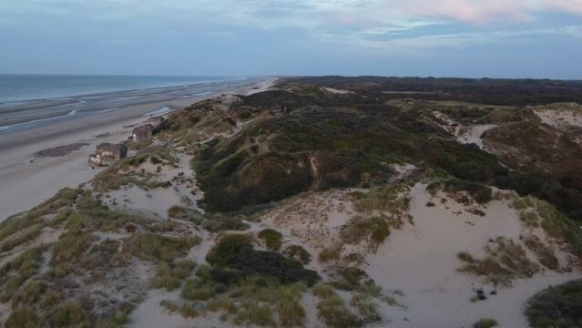 Aerial view of the sunset illuminating the famous sand dunes protecting soldiers during the war near Dunkirk, France. 