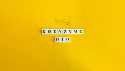 Obraz premium Coenzyme Q10, CoQ10 Banner with Structural Chemical Formula. Block Letter Tiles on Yellow Background. Minimalist Aesthetics.