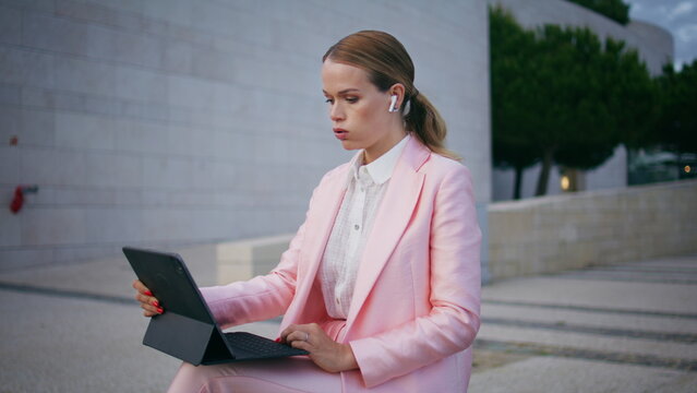Worried freelancer working laptop sitting bench outdoors closeup. Business woman