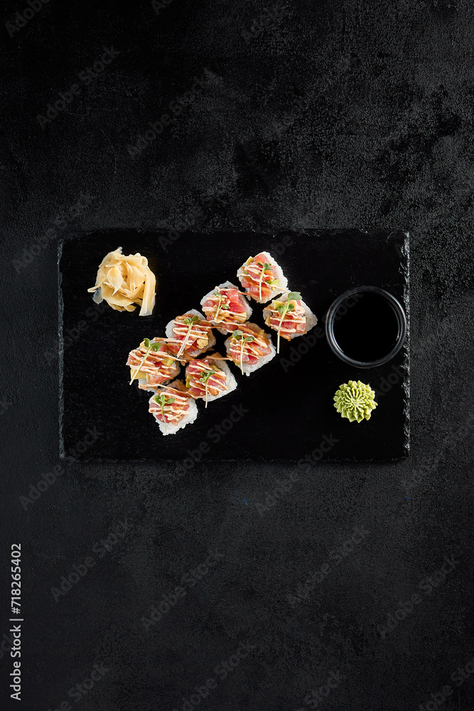 Canvas Prints tuna tartare and avocado roll sushi, top view on dark slate background