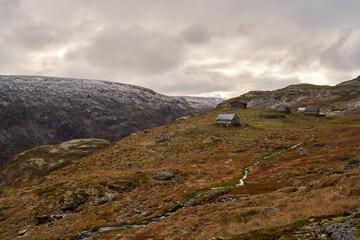 Fototapeta premium Very old, simple, traditional stone and log cabins on the Aurland highland in Norway during late autumn