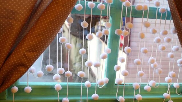 Close up view of window with decoration, people behind glass out of focus