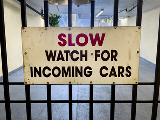 Slow down sign on a garage gate - 718276026