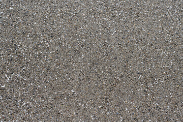 Sea coarse sand top view flat layout. Gray coarse sea sand on the seashore. Sea sand closeup flat lay.
