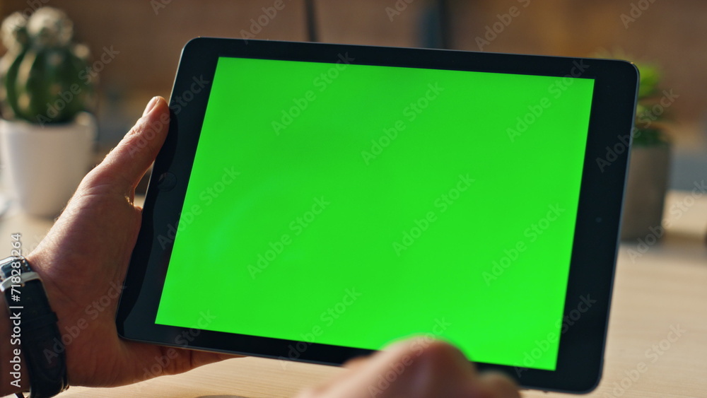 Wall mural hands touching mockup tablet searching information in internet indoors close up.