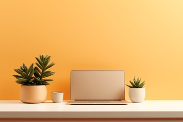 Minimalistic workspace with a modern laptop, smartphone, and potted succulent on a sleek desk

