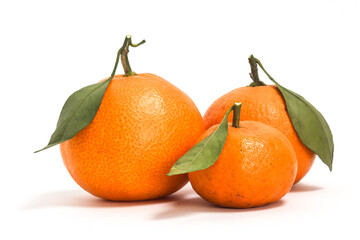 Three fresh organic orange delicious fruit side view with green leaves isolated on white background clipping path