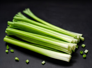 Fresh green onion on black background