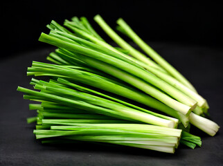 Fresh green onion on black background