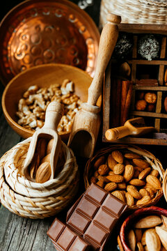 wood scoops, nuts and spice inside of vintage box which devided on sections.	