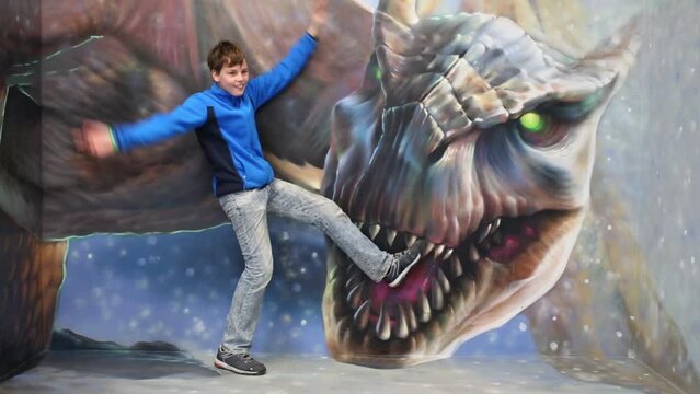 Boy with legs in dragon mouth in optical illusions Museum 