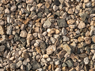 Closeup top view of textured industrial crushed stone background