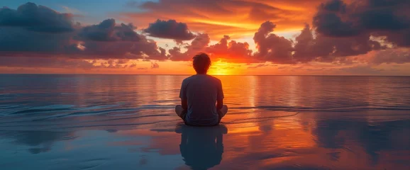 Fotobehang man practicing yoga on a lake at the sunset, calmness and emotional healing © KeepStock