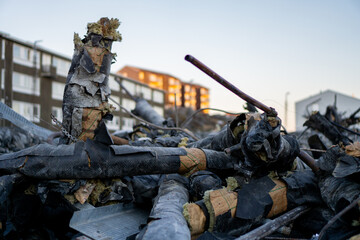 Old, broken, pipes set for removal, with buildings in the background - Nuuk, Greenland