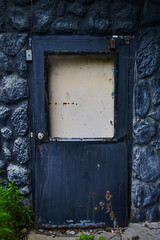 Weathered Blue Door in Black Stone Wall, Abandoned Hotel, Ohio