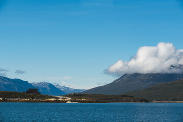 Photo of Greenland's nature, with a boat and a cottage,