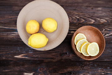 Still life of fresh lemons and elderberry flowers. Ingredients for lemonade and juice from syrup from elderberry flowers. Seasonal summer food. Healing with a healthy diet with ambucus medicines