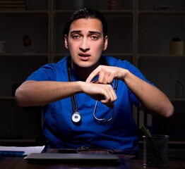 Young male doctor in the hospital at night