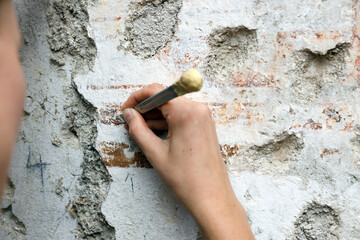 Restorer Hands Working on Ruined Parts of Painted Wall Restoring what is possible and making all...