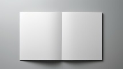  an open white book on a gray background with a shadow on the bottom of the book and a shadow on the bottom of the book. - obrazy, fototapety, plakaty