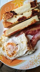 bacon with eggs on plate