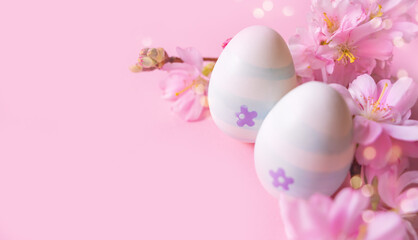 Close up of easter eggs and cherry flowers on a pink background with bokeh and copy space. Church Christian holidays, Christianity, Easter background
