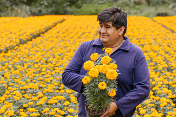 Portrait of a proud Mexican cempasuchil producer showing his flowers