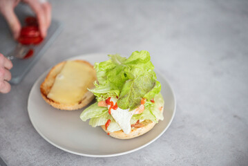 Delicious healthy sandwich for a snack breakfast in men's hands. Toast bread tomato ham leaf salad