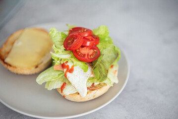 Delicious healthy sandwich for a snack breakfast in men's hands. Toast bread tomato ham leaf salad