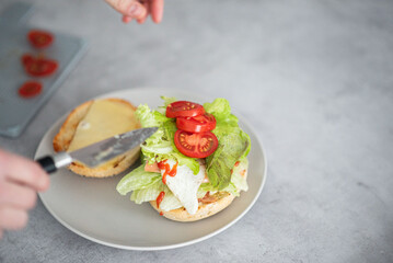Delicious healthy sandwich for a snack breakfast in men's hands. Toast bread tomato ham leaf salad