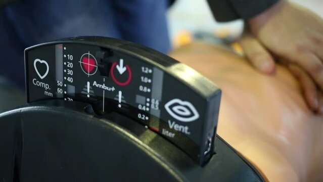 Dummy for practicing first aid skills, person doing indirect heart massage