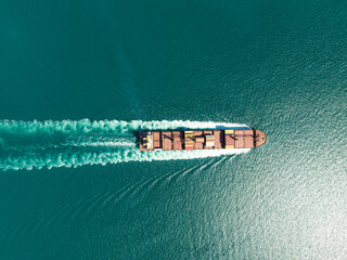  Aerial top view of cargo maritime ship with contrail in the ocean ship carrying container and running for export concept technology freight shipping by ship forwarder mast