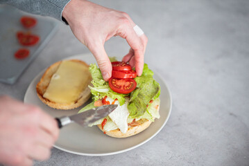 Delicious healthy sandwich for a snack breakfast in men's hands. Toast bread tomato ham leaf salad