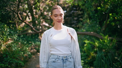 Romantic girl strolling park enjoying calm nature beauty close up. Woman walking