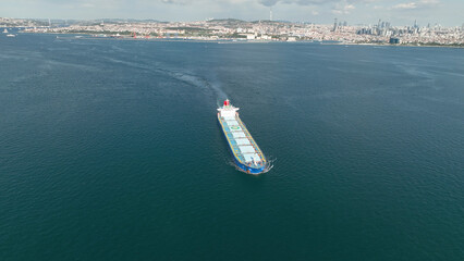 Aerial top view of cargo maritime ship with contrail in the ocean ship carrying container and...