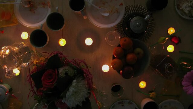 People toke food from holiday table with candles. Timelapse