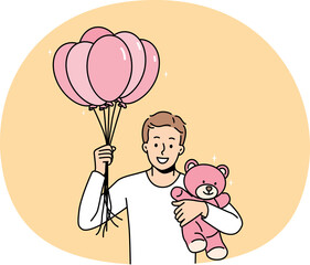 Smiling young man with air balloons and teddy bear in hands making surprise to loving girlfriend. Happy guy make present or gift to lover on birthday or anniversary.