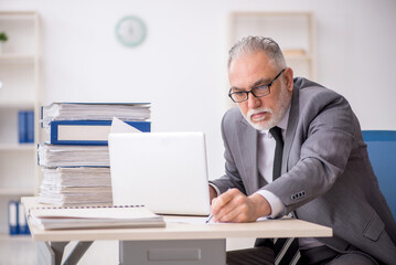 Old male employee and too much work in the office