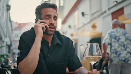Calling man drinking wineglass street cafe close up. Businessman talking phone