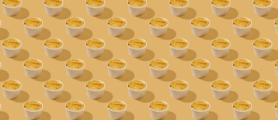 Pattern of cannelloni noodle in wooden bowl yellow pastel background